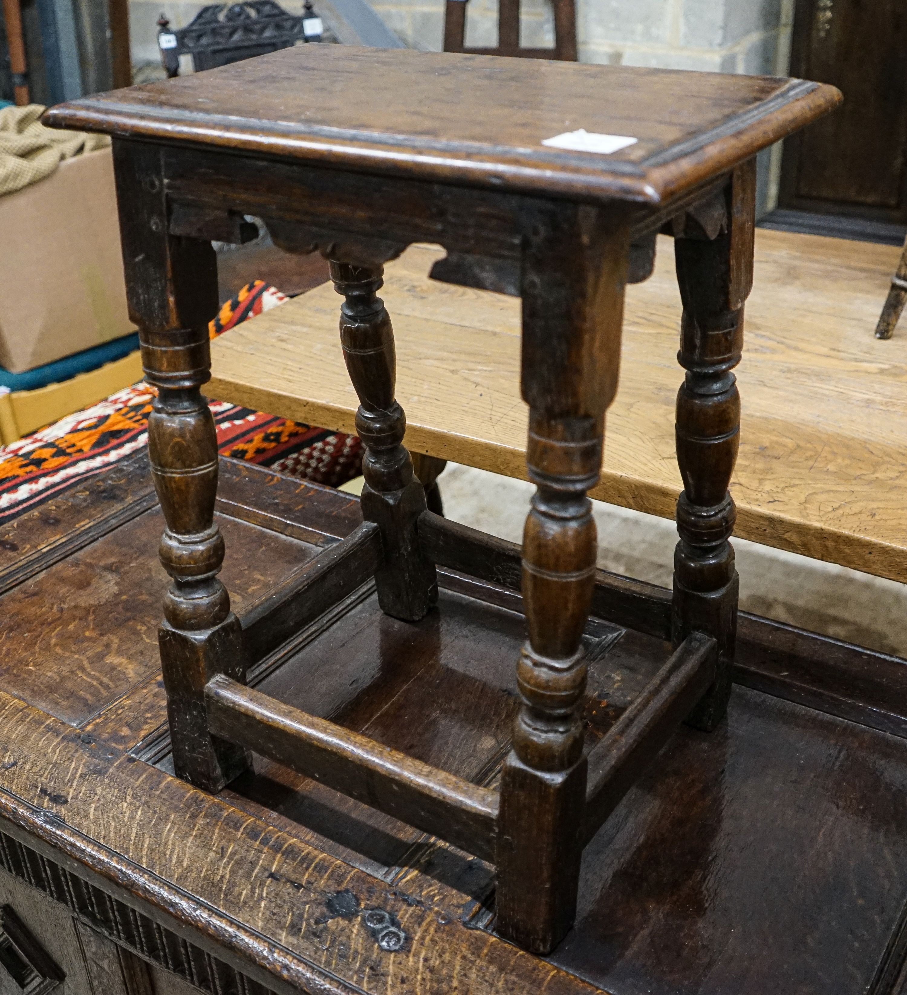 A 17th century style oak joint stool, with turned legs and carved apron, width 46cm, depth 27cm, height 56cm